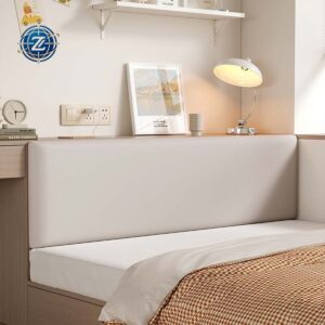 Pale upholstered headboard with broad padded panels behind a bed