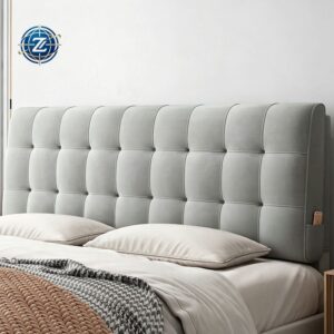 Light gray tufted upholstered headboard behind a bed