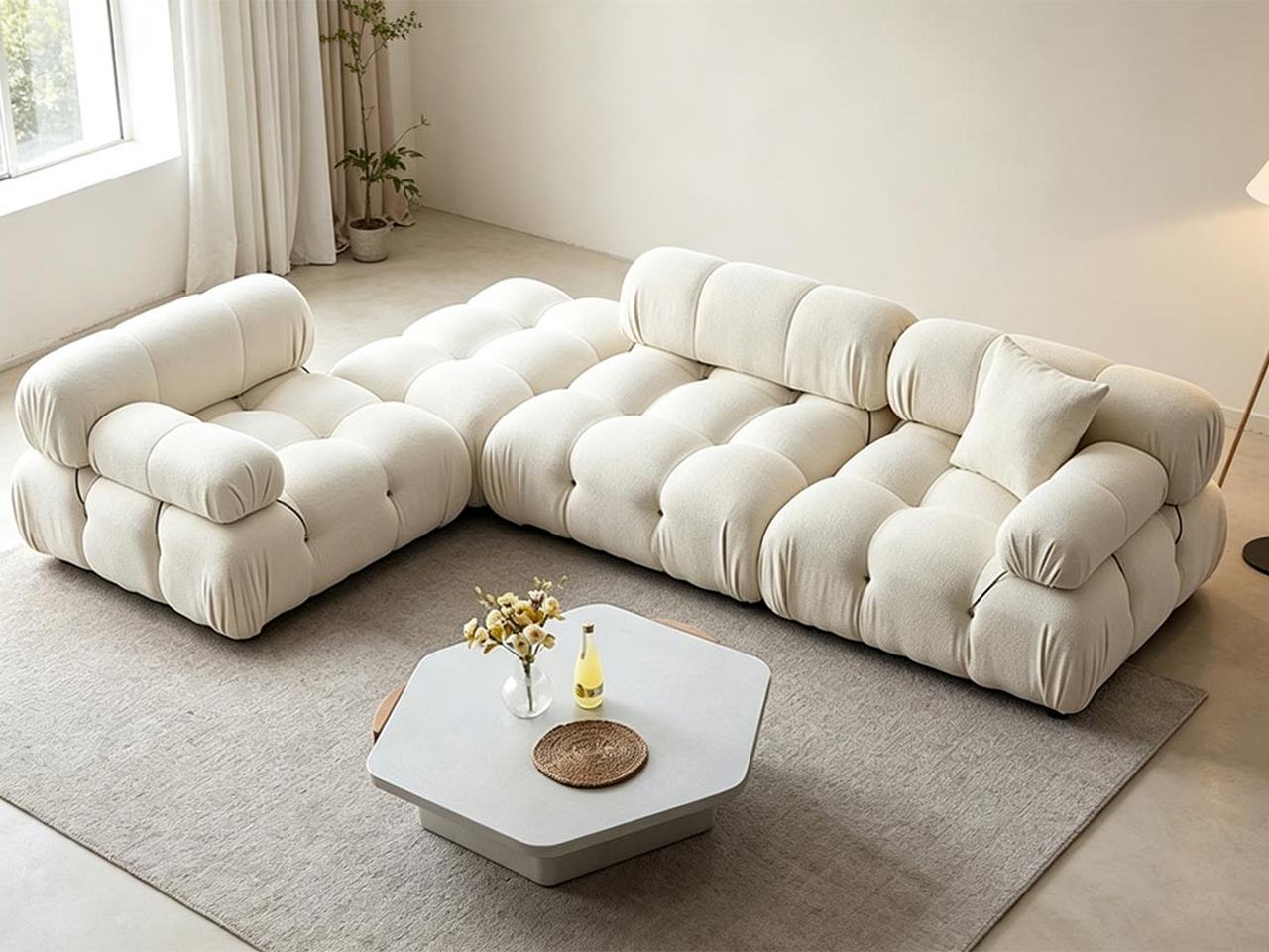 Cream modular sofa and chaise around a round coffee table